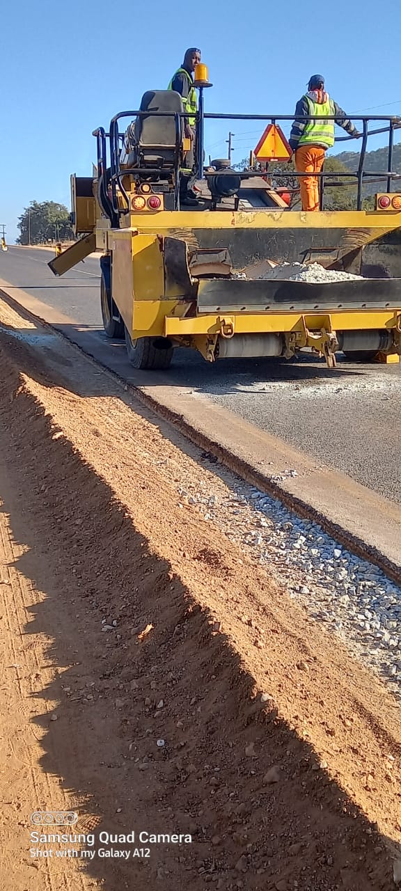 Road construction crew and paving machinery working on the R36 shoulder in Tzaneen